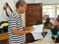 Stanley Greaves at costume design work shop with patterns in hand