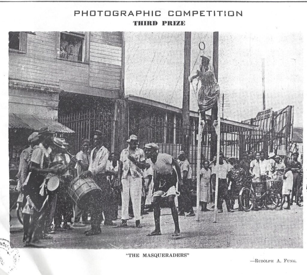 “The Masqueraders” by Rudolph A. Fung
The earliest image of Masquerade in this exhibition is a photocopy of Rudolph A. Fung’s prize-winning photograph “The Masqueraders” in the 1958 Chronicle Christmas Annual.  What catches your attention ?